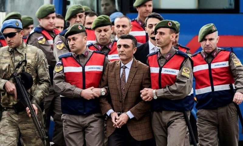 Security forces escorting suspects ahead of a hearing in Mugla where 47 people went on trial over alleged coup links earlier this month