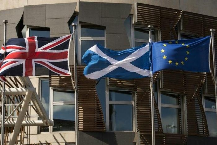 The British, Scottish and EU flags in front of the Scottish Parliament in Edinburgh