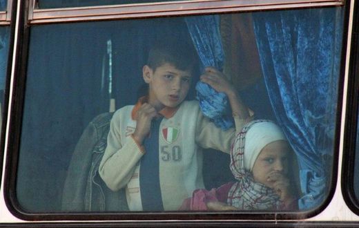 Syrian civilians being evacuated from the government-held towns of Fuaa and Kafraya, which have been under crippling siege for more than two years, on buses near the rebel-held transit point of Rashidin on April 19, 2017