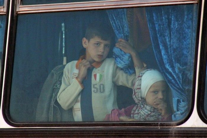 Syrian civilians being evacuated from the government-held towns of Fuaa and Kafraya, which have been under crippling siege for more than two years, on buses near the rebel-held transit point of Rashidin on April 19, 2017