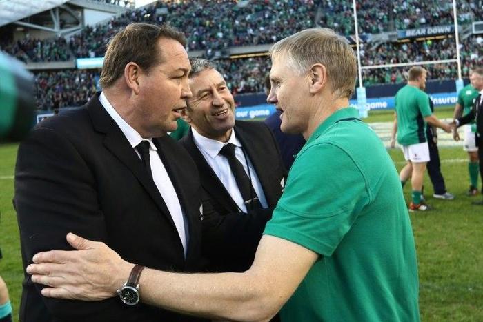 Ireland's head coach Joe Schmidt (R) shakes hands with New Zealand's counterpart Steve Hansen (L) and assistant coach Wayne Bennett following the final whistle of their rugby union match at Soldier Field in Chicago, on November 5, 2016
