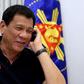 Philippines' President Rodrigo Duterte talks to US President-elect Donald Trump on the phone at Legaspi Suites in Davao City