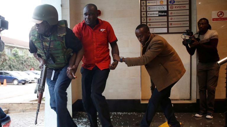 A Flying Squad operative helps civilians during the January 15 attack at Dusit Complex, Nairobi