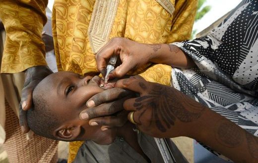 Health worker tries to immunise a child during a vaccination campaign against polio at Hotoro-Kudu, Nassarawa district of Kano in northwest Nigeria, on April 22, 2017