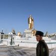Soldiers stand guard near a golden statue of Turkmenistan's first president Saparmurat Niyazov in the capital Ashgabat
