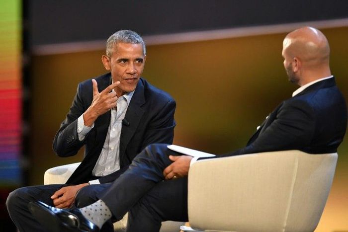 Former US president Barack Obama is interviewed by his former White House chef Sam Kass in front of a paying audience in Milan, Italy