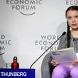 Swedish youth climate activist Greta Thunberg (C) delivers a mesage on climate change at Davos that business executives called "moving" and "inspiring"