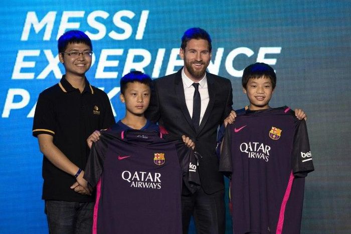 Barcelona's forward Lionel Messi poses for a photo with Chinese fans in Beijing on June 1, 2017