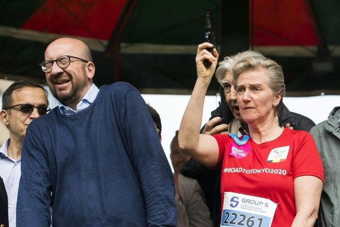 Prime Minister Charles Michel reacts as Princess Astrid of Belgium fires the starting pistol for a running race in Brussels on May 28
