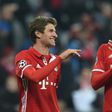 Bayern Munich's Thomas Mueller (L) jokes with teammate Mats Hummels after their UEFA Champions League match against Arsenal, in Munich, on February 15, 2017