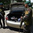Philippine policemen check a car at a checkpoint in Iligan City, on the southern island of Mindanao, on May 24, 2017
