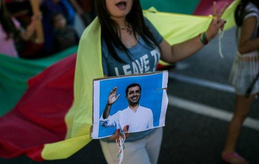 A Kurdish woman holds a photo of arrested HDP co-leader Selahattin Demirtas at a protest in Athens, Greece