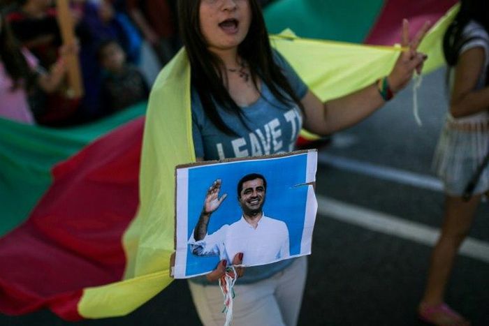 A Kurdish woman holds a photo of arrested HDP co-leader Selahattin Demirtas at a protest in Athens, Greece