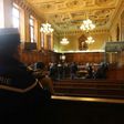 A gendarme looks towards reporters in the courtroom of a Special Court of Assizes at the Paris courthouse, prior to the start of the trial of a jihadist network known as the "Cannes-Torcy cell", on April 20, 2017