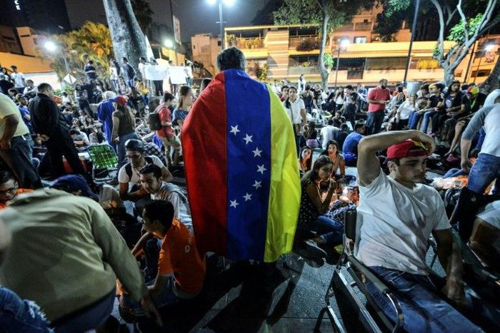 People participate in a march paying tribute to student Juan Pablo Pernalete, killed on April 26 by the impact of a gas grenade during a protest, in Caracas, on April 29, 2017