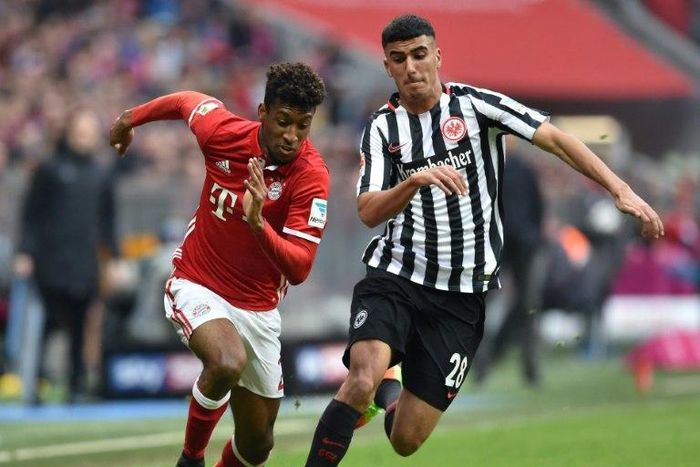 Bayern Munich's Kingsley Coman (L) and Frankfurt's Aymen Barkok vie for the ball during their match in Munich, southern Germany, on March 11, 2017