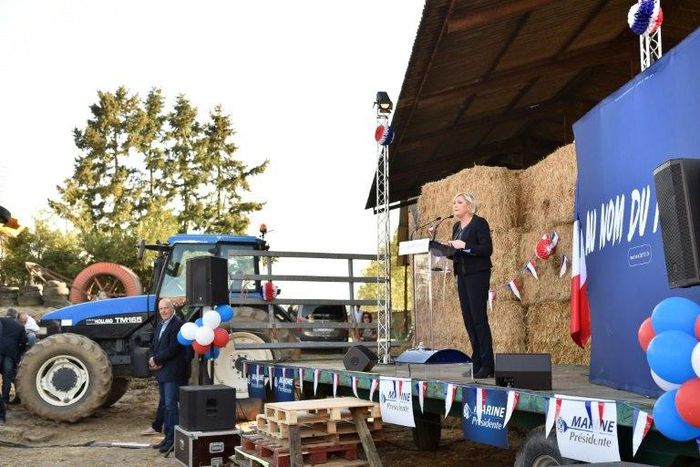 French presidential election candidate for the far-right Front National (FN) party Marine Le Pen (R) delivers a speech during a campaing rally at the Puybonnieux farm in Pageas, near Limoges, on April 13, 2017