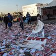 A girl drags a banner reading "yes" across piles of "yes" leaflets in the Kadikoy district of Istanbul