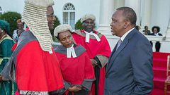 President Uhuru Kenyatta chats with Chief Justice David Maraga after the swearing-in of new judges of the High Court at State House, Nairobi.