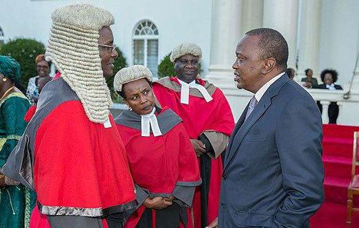 President Uhuru Kenyatta chats with Chief Justice David Maraga after the swearing-in of new judges of the High Court at State House, Nairobi.