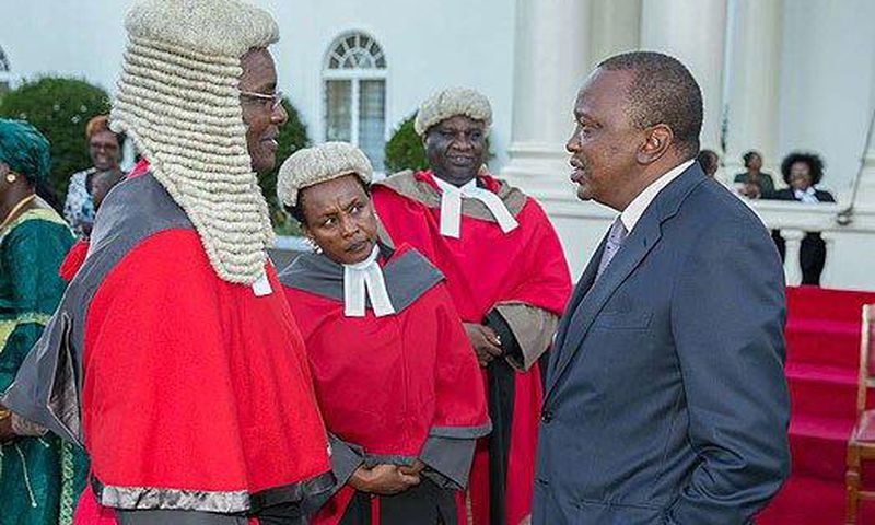 President Uhuru Kenyatta chats with Chief Justice David Maraga after the swearing-in of new judges of the High Court at State House, Nairobi.