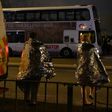 Concert goers wait to be picked up after a suspected terror attack during a pop concert by Ariana Grande in the northern English city of Manchester