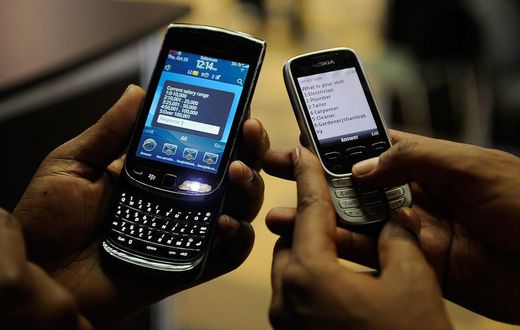 File image of mobile phone users engaged on their handsets