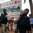 Soldiers stand near The Hotel Etoile du Sud on March 13, 2016, in Grand Bassam, during a commemoration ceremony for the first anniversary of the 2016 Grand Bassam beach terrorist attack, resulting in the death of 19 people