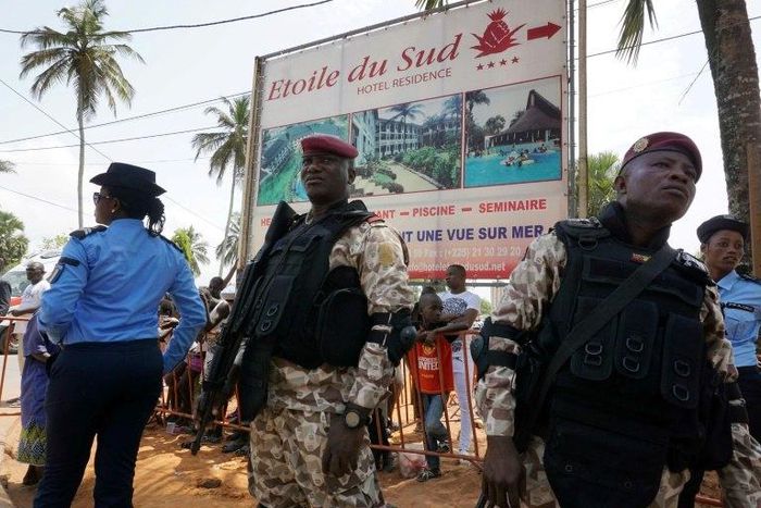 Soldiers stand near The Hotel Etoile du Sud on March 13, 2016, in Grand Bassam, during a commemoration ceremony for the first anniversary of the 2016 Grand Bassam beach terrorist attack, resulting in the death of 19 people