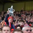 Lincoln fans celebrate after winning the English FA Cup fifth round football match between Lincoln City and Burnley February 18, 2017