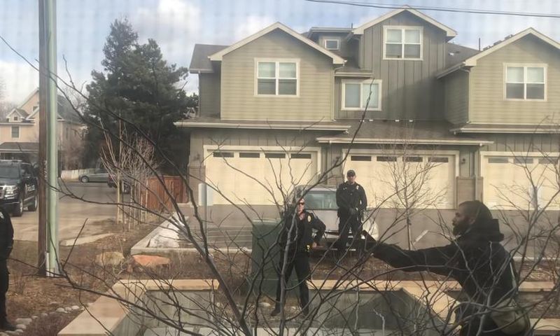 White officer placed on leave after detaining black man picking up trash in front of his building