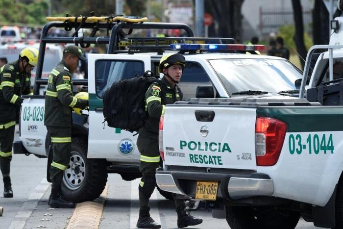 Security forces at the site of a car bombing at a police cadet training school in Bogota