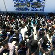 Illegal migrants, who were found by Libyan security forces while waiting in a depot in Tripoli's eastern suburb of Tajoura prior to being smuggled to Europe, gather at the new Tajoura detention centre in the Libyan capital on May 9, 2017