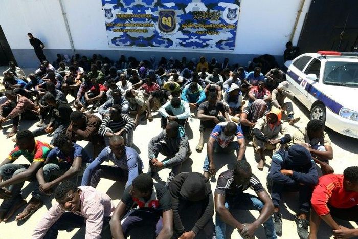 Illegal migrants, who were found by Libyan security forces while waiting in a depot in Tripoli's eastern suburb of Tajoura prior to being smuggled to Europe, gather at the new Tajoura detention centre in the Libyan capital on May 9, 2017