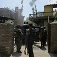 Indian army soldiers stand next to a burning house where two Kashmiri rebels were killed during a gunfight in the Tral area south of Srinagar on May 27, 2017