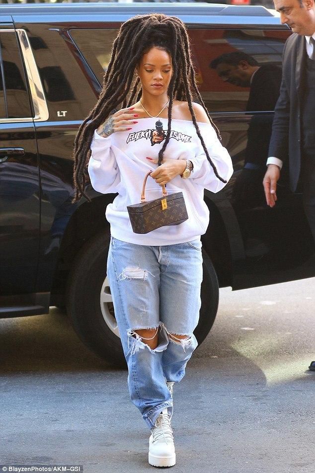 Rihanna wearing distressed boyfriend jeans (Courtesy)