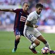 Real Madrid's Isco (R) fights for the ball with Eibar's midfielder Pedro Leon during their Spanish La Liga match in Madrid, in October 2016