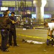 Police officers and investigators work at the scene of a bomb blast that killed at least one person near a bus terminal in Jakarta, on May 24, 2017