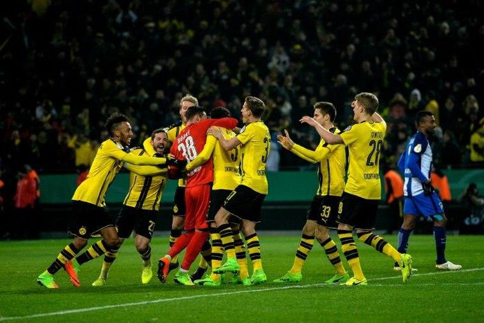 Dortmund's goalkeeper Roman Buerki celebrates with his teammates after the penalty shoot-out of the German Cup DFB Pokal round of 16 football match against Hertha Berlin February 8, 2017