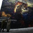 Men dressed in Red Army World War II uniforms take part in the opening of a street art-style painting promoting the new Russian film "The Panfilov 28" in Moscow