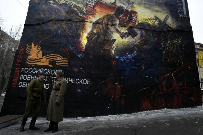 Men dressed in Red Army World War II uniforms take part in the opening of a street art-style painting promoting the new Russian film "The Panfilov 28" in Moscow