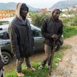 Migrants stand on the outskirts of the Moroccan city of Fnidek on February 18, after forcing their way through a border fence between Morocco and the tiny Spanish enclave of Ceuta