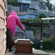 Juana Cerrato prepares her son's wake at a football pitch next to her house at the "Mirador de Oriente" shanty town in Tegucigalpa on February 7, 2017