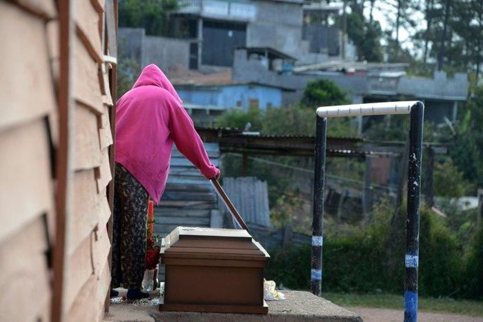 Juana Cerrato prepares her son's wake at a football pitch next to her house at the "Mirador de Oriente" shanty town in Tegucigalpa on February 7, 2017