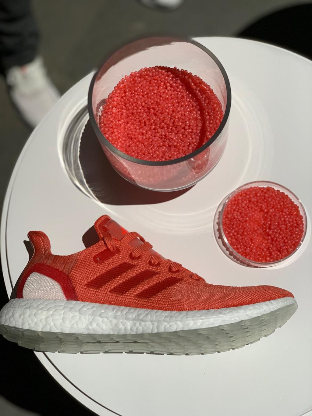 Another colorway of the shoe, along with the pellets that are created after the recycling process.