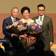 Hong Kong's new chief executive Carrie Lam (C) has pledged to mend political rifts after winning a vote dismissed as a sham by democracy activists