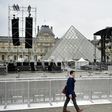 People walk through the courtyard of the Louvre following a security alert