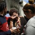 Relatives of the victims of a fire at a government-run children's shelter in San Jose Pinula, cry outside the morgue in Guatemala City