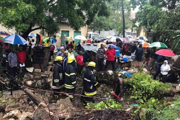 Rescuers pull bodies of people killed after a wall collapsed on a house in Mbaraki, Mombasa, May 8, 2017.