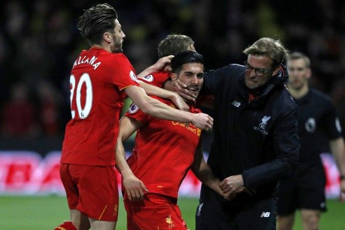 Liverpool's midfielder Emre Can (C) celebrates with Adam Lallana (L) and manager Jurgen Klopp after scoring against Watford on May 1, 2017